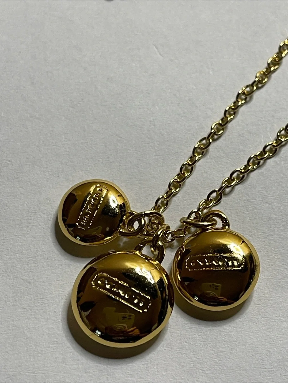 Coach Gold Pendant Necklace with Triple Medallion Reversible Charms